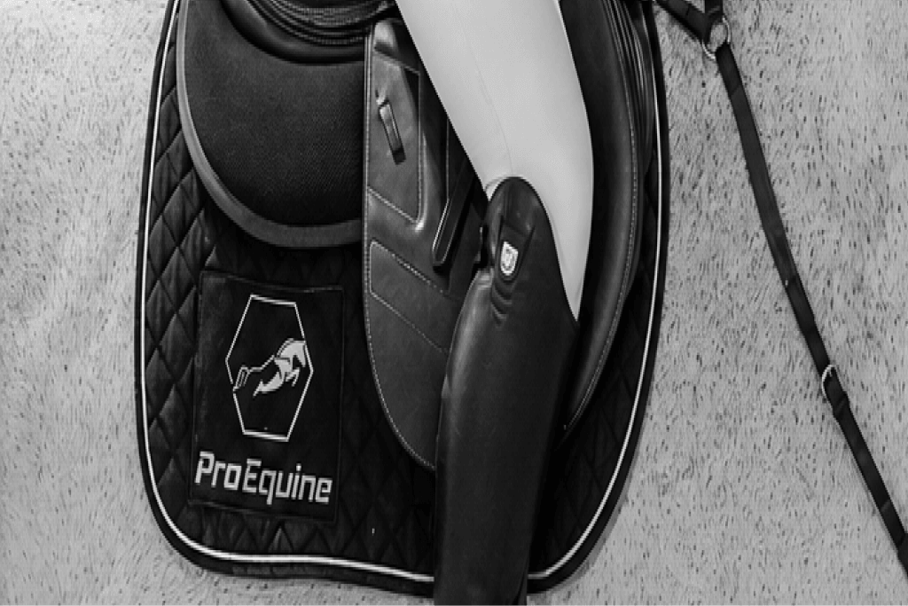 Rider wearing ProEquine saddle equipment with the gold ProEquine logo